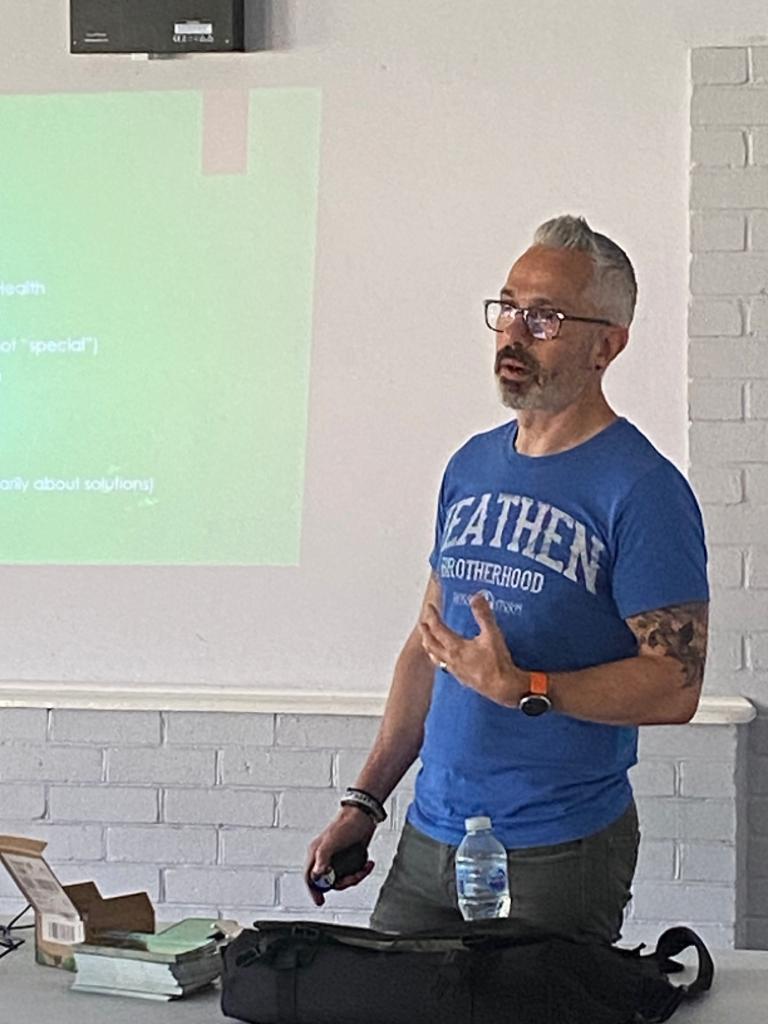 A photograph of a man giving a talk in Leighton Buzzard