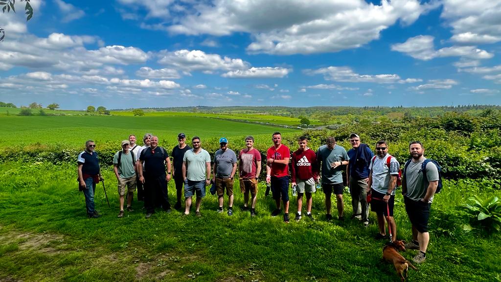 A photo of men walking in nature. Nature walks help calm your mental health.